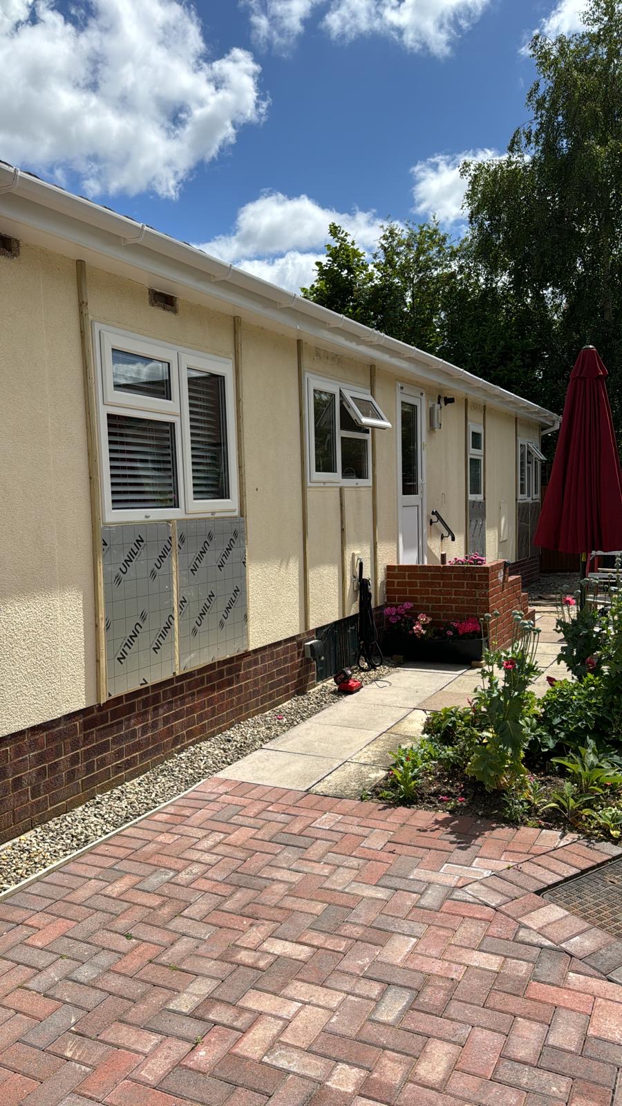 Cream clad park home with new paving