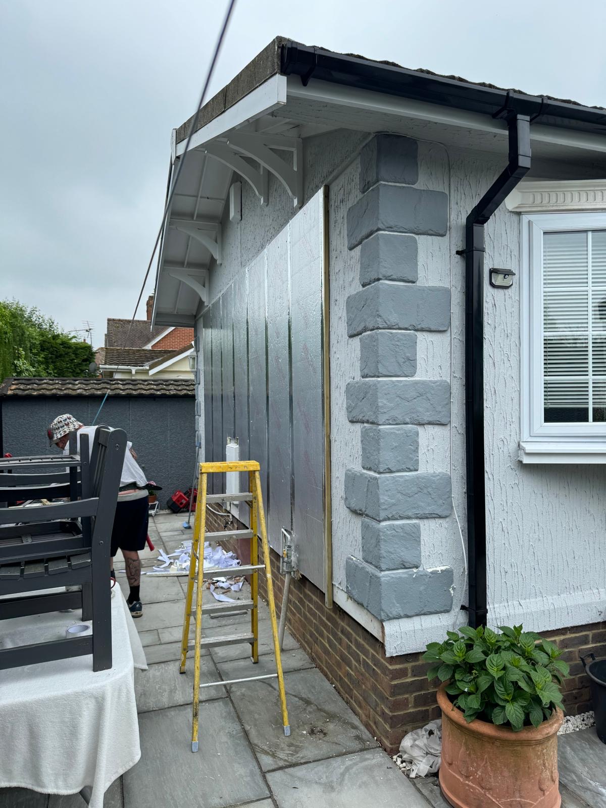 Grey clad park home with stone column detail