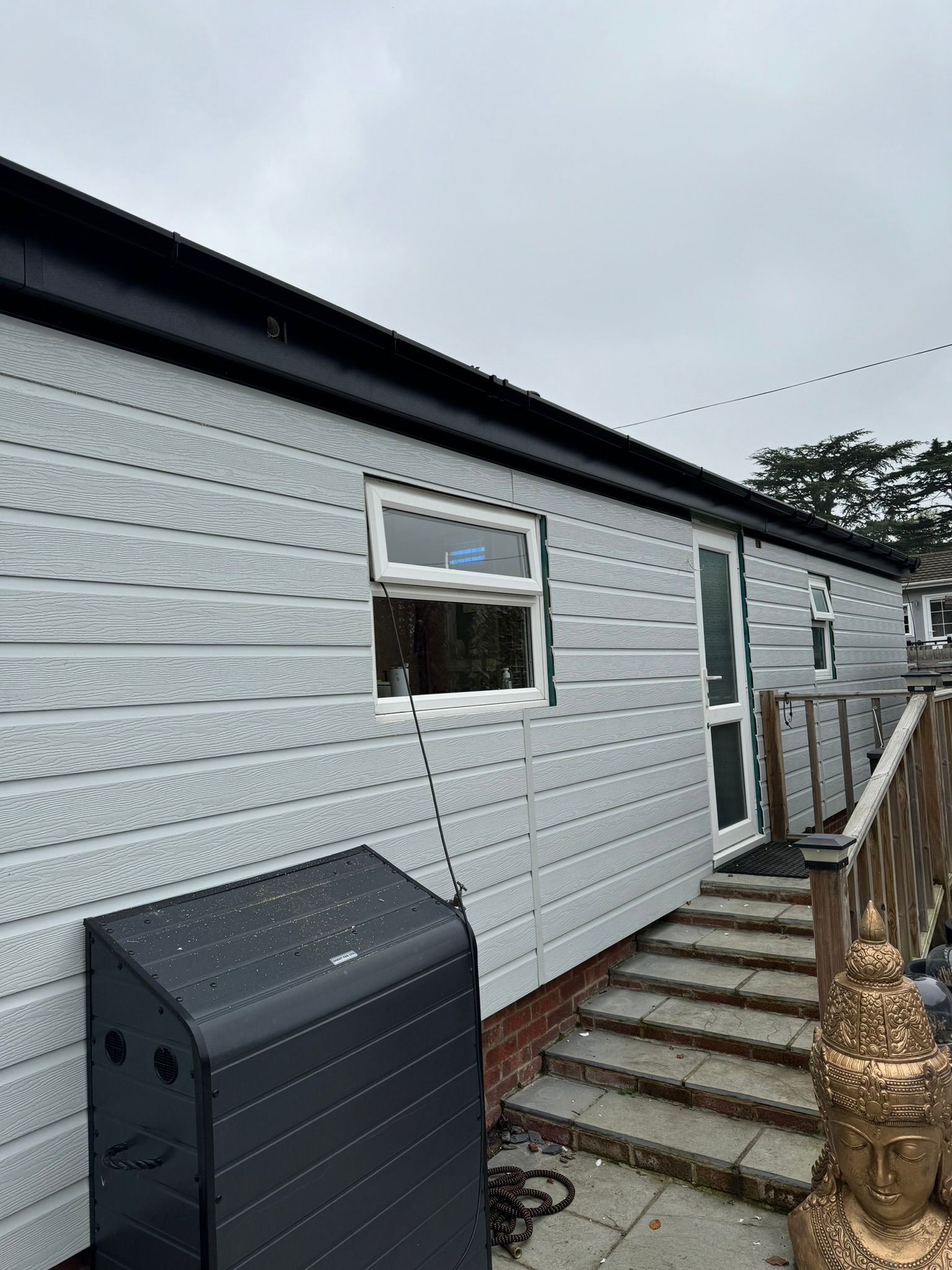 Finished grey clad park home with smart black guttering and fascia