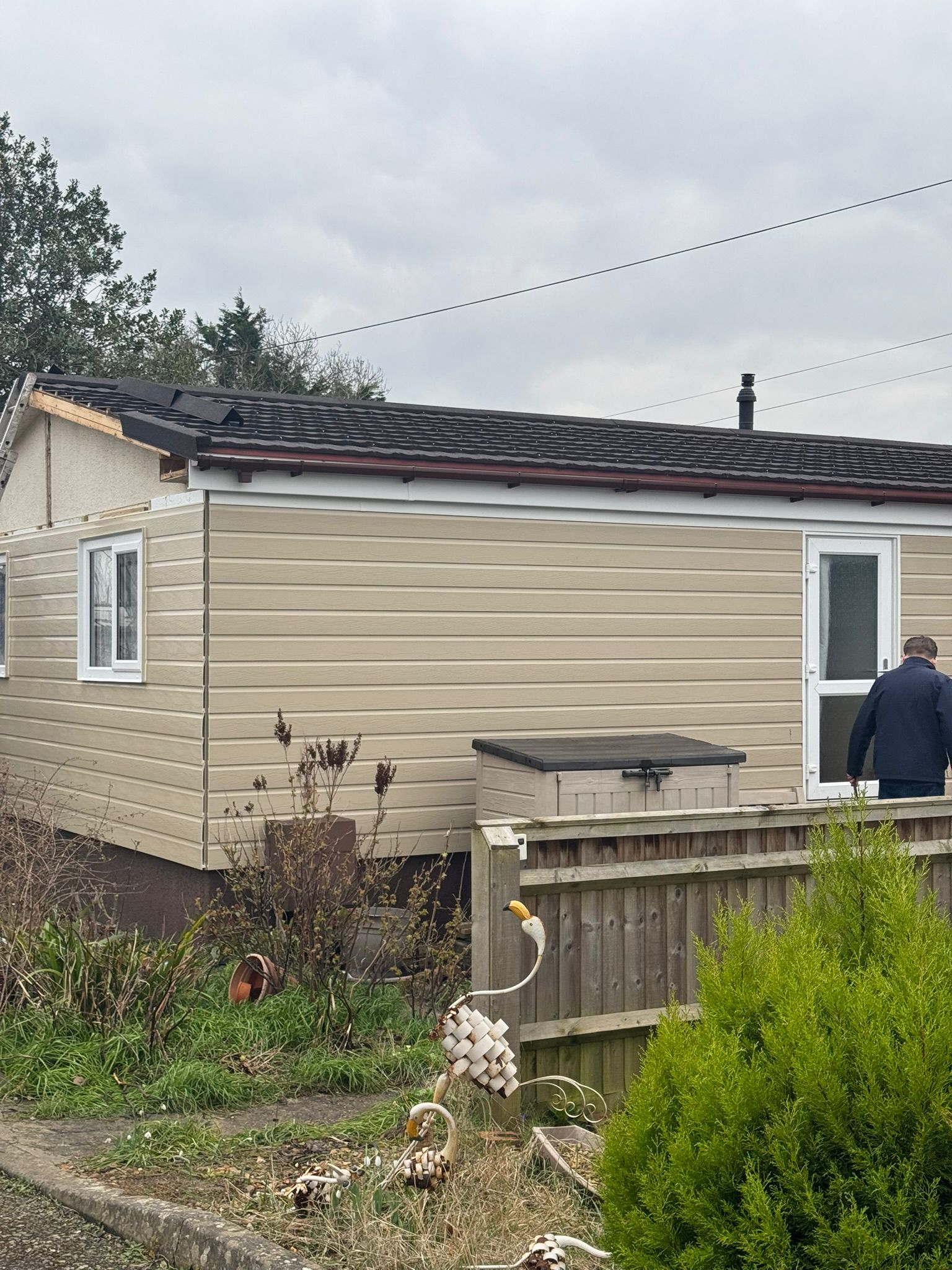 Completed tan clad park home with new black tiled roof