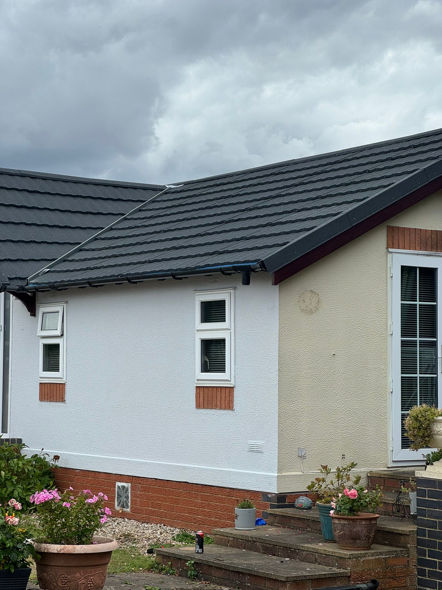 Renovated park home with fresh white render and new tiled roof