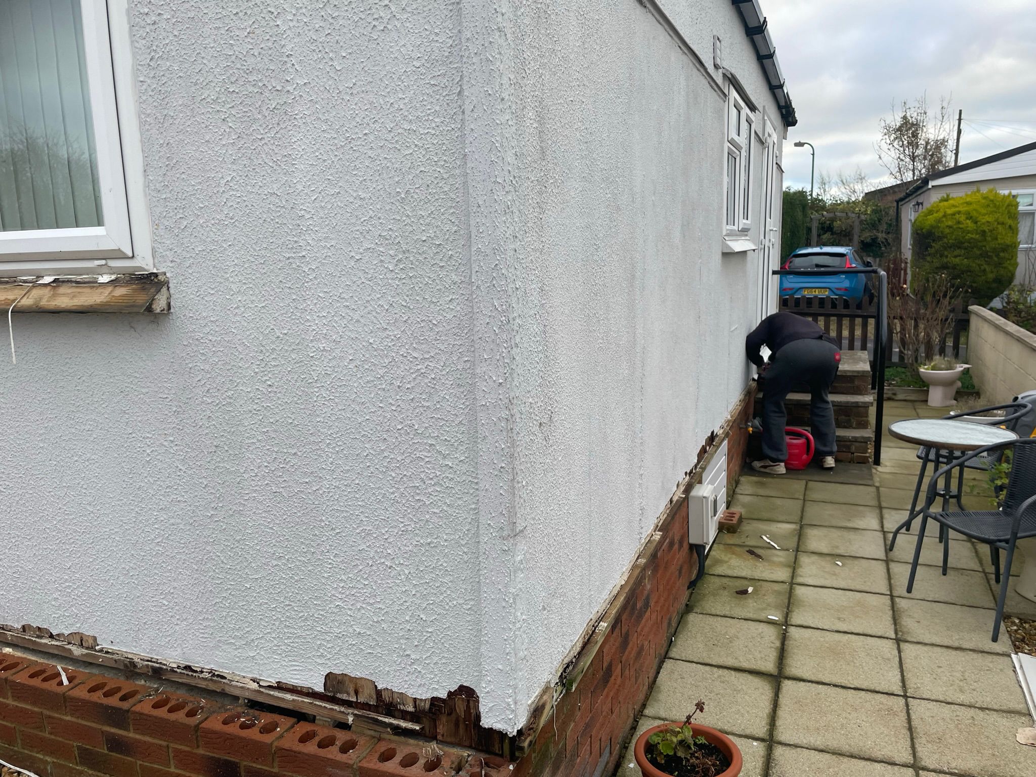 Repairing the rotten timber base rail above the brick foundation during renovation
