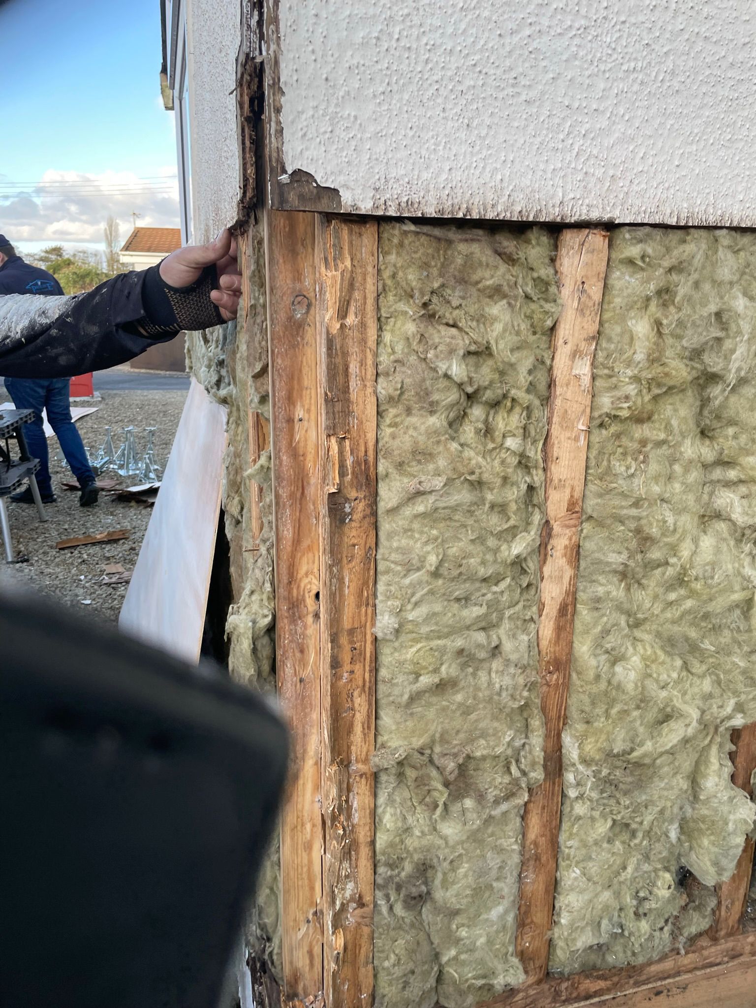 Close-up of decayed timber studwork and perished fibreglass insulation before repair
