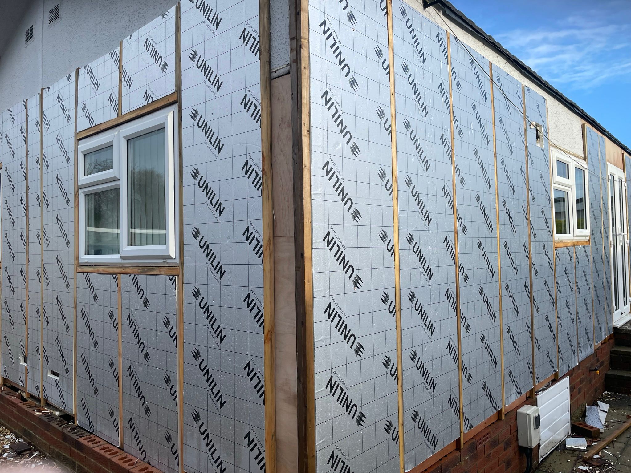 Unilin insulation boards fixed to fresh timber battens around a park home corner