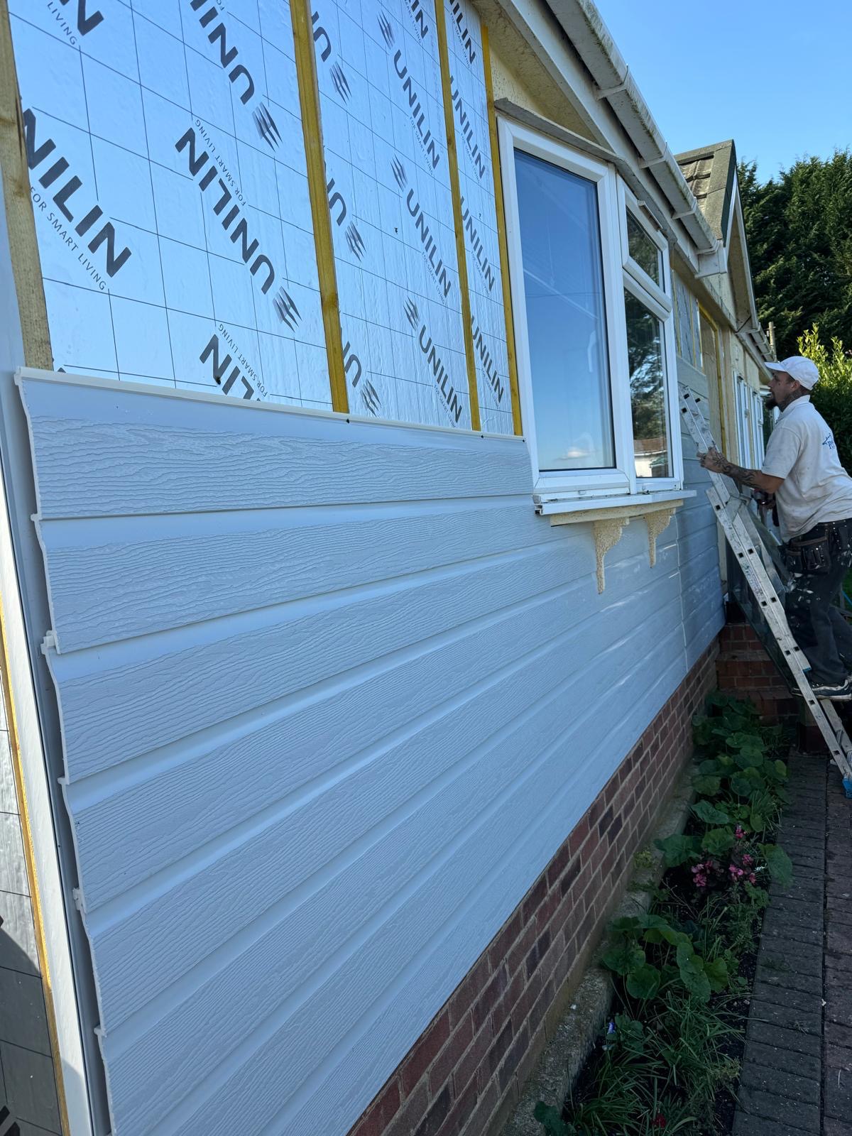 New cladding being installed on a park home exterior