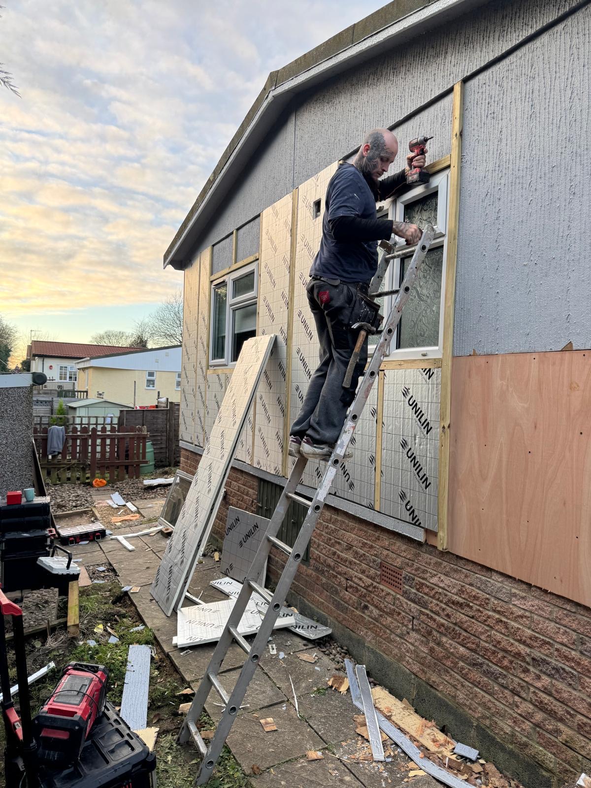 Cladding installation continuing into the evening