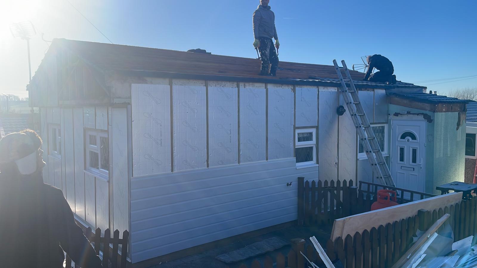 Roof being wrapped and weatherproofed during works